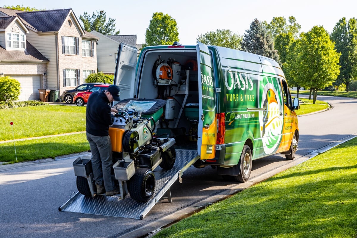 Oasis crew unloading ride on fertilizer from van -