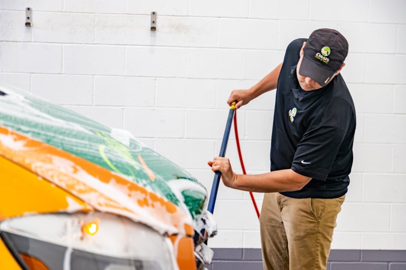lawn care technician cleaning van 3