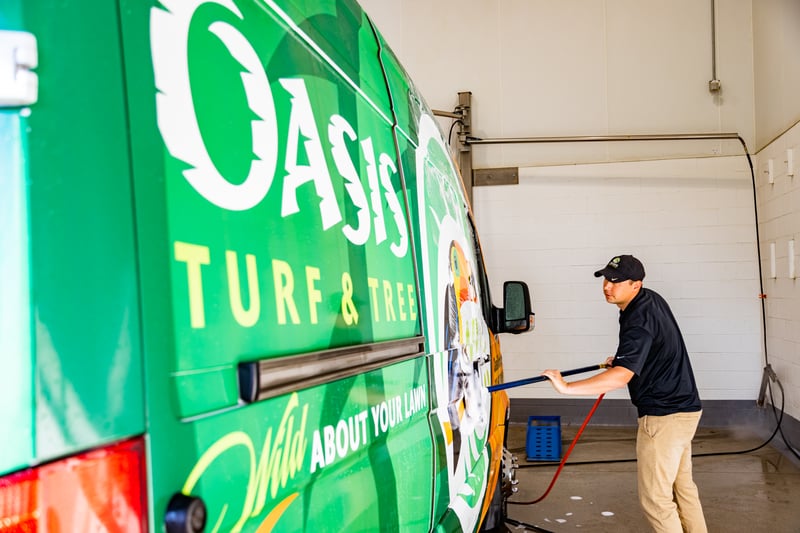 lawn care technician cleaning van 5