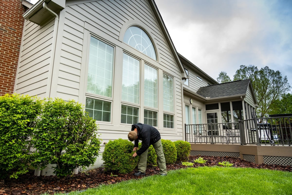 technician pruning shrubs