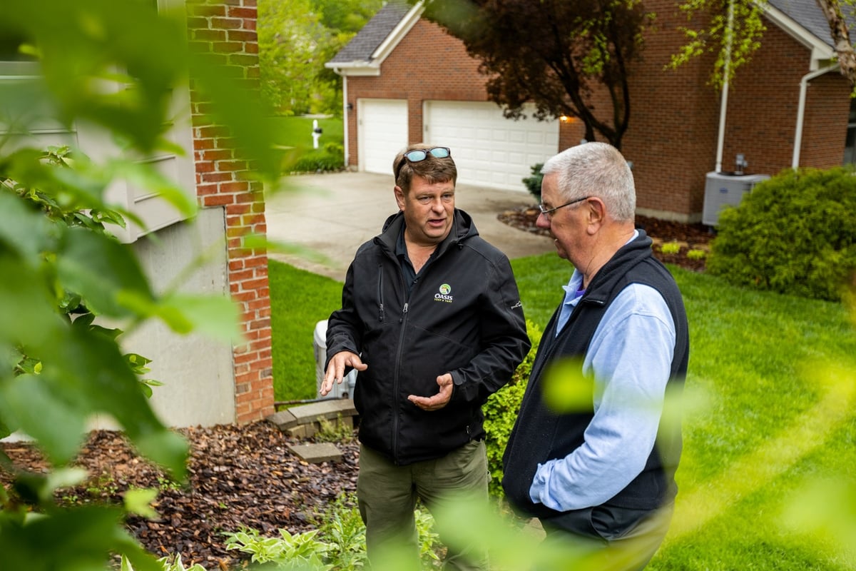 plant health care technician discusses services with client