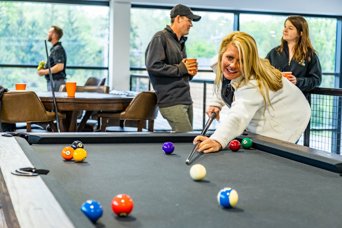 team plays pool at office building