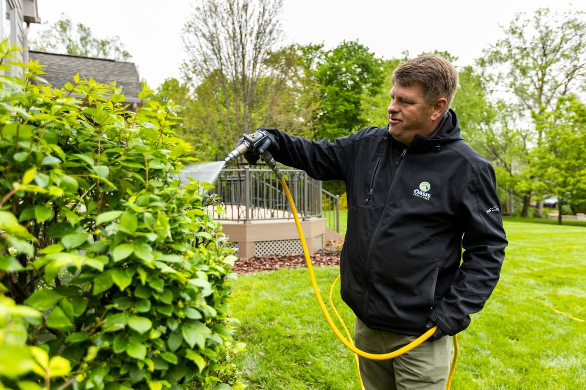 plant health care technician sprays trees