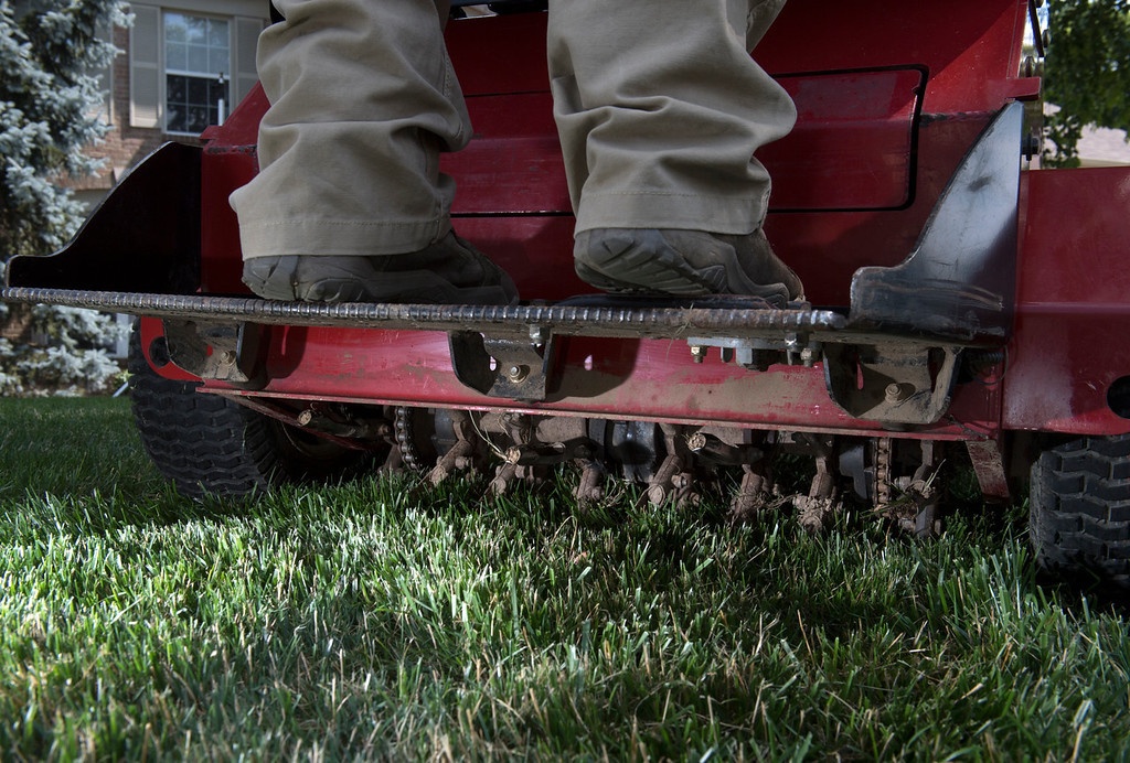 aeration machine being operated by landscape professional
