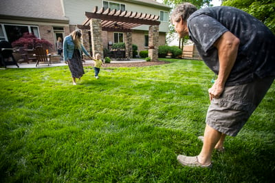 family playing in healthy lawn with no crabgrass