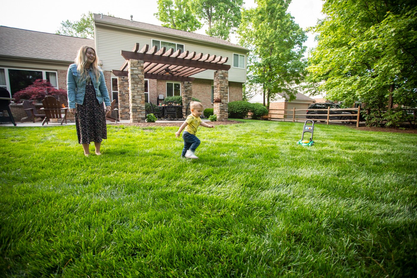 happy family playing on a weed-free lawn