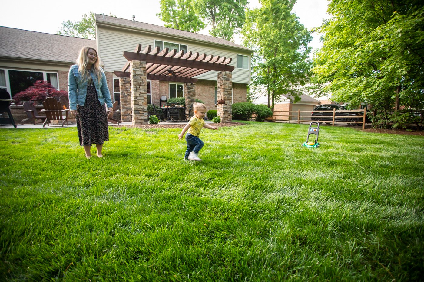 Happy lawn care customer in healthy lawn