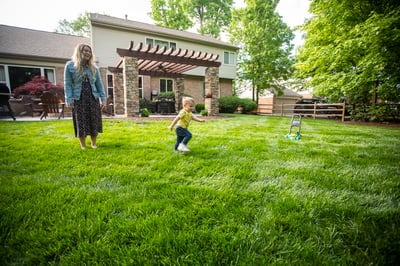 Family playing in lawn with pest control 