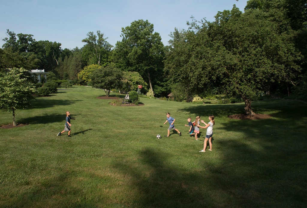 kids-playing-soccer-lawn