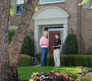 Lawn care salesman talking with a customer