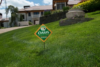 Oasis Turf & Tree lawn care sign in lawn with no crabgrass