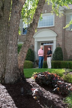 lawn care technician discussing lawn lime treatment with customer in Ohio