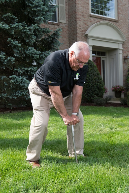 Oasis lawn care technician testing soil