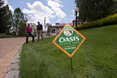 Oasis turf and tree lawn care sign in nice lawn in Dayton, Oh