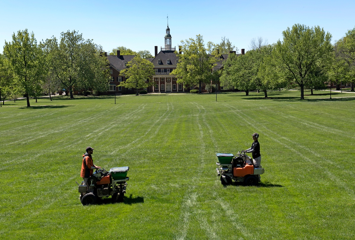 Lawn care technicians applying fertilizer