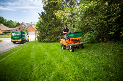 Oasis lawn care technician treating lawn in Cincinnati