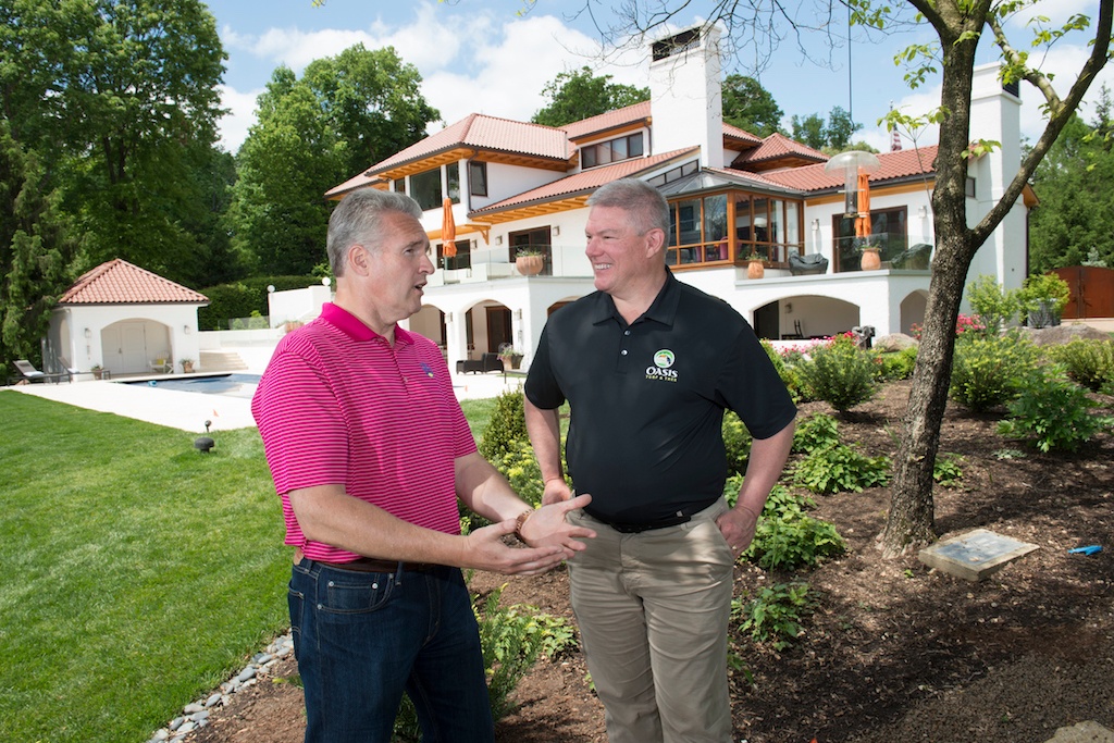lawn care expert meets with customer