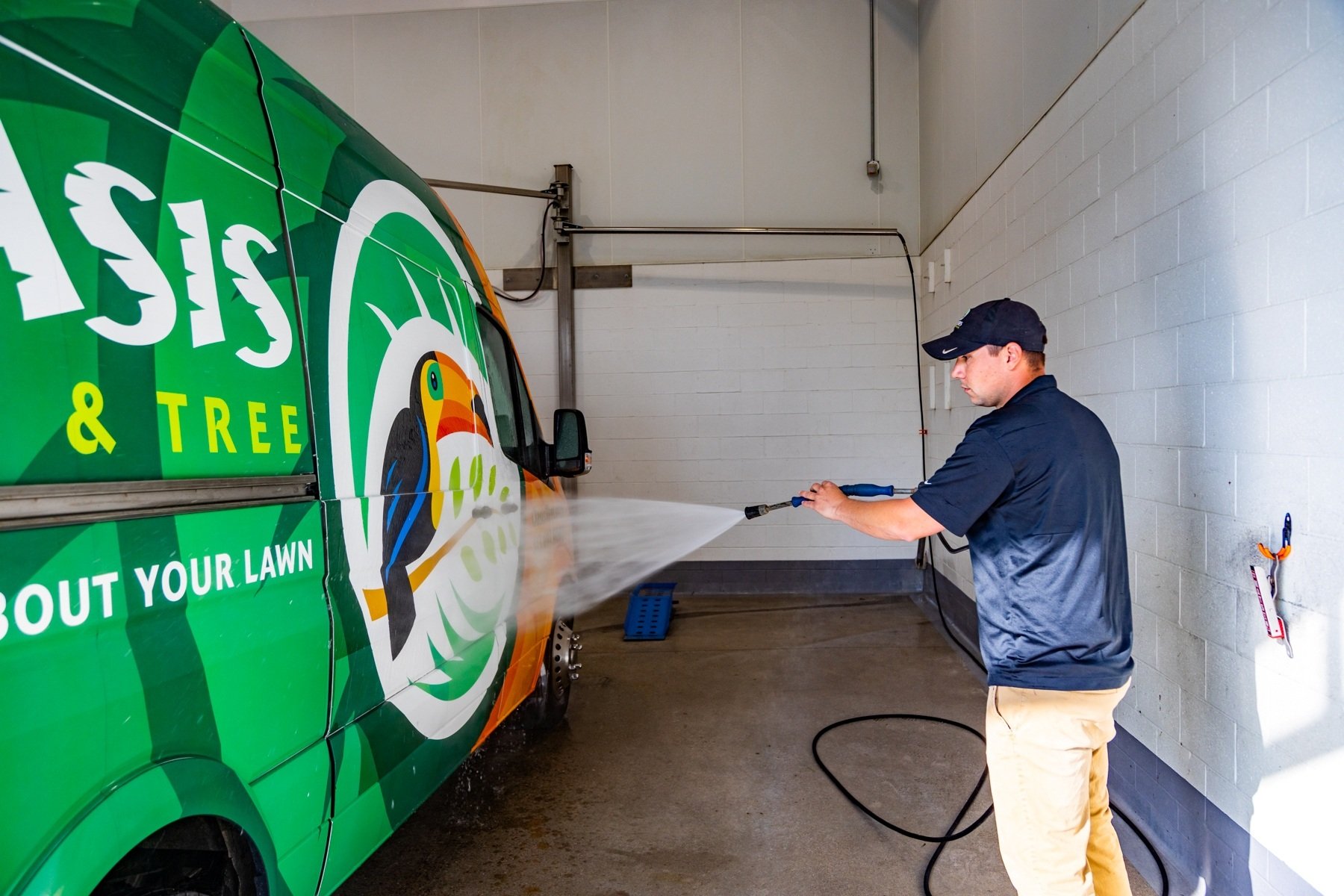 Oasis crew washing van and equipment in wash bay