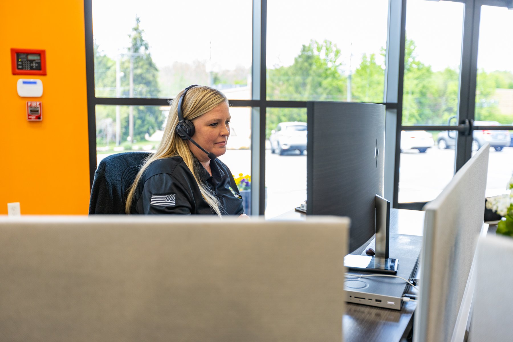 oasis team works at computer with headset