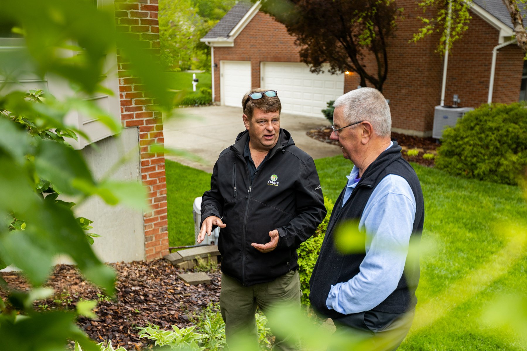 lawn technician and customer in yard lawn technician and customer in yard