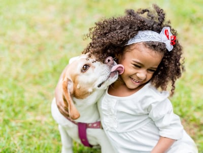 dog and little girl in lawn